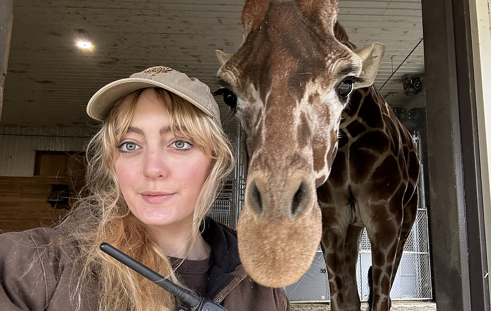 Liv posing with a giraffe.