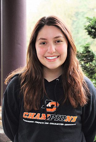 Olivia Weaver, smiling and wearing an L&C shirt.