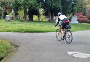 Image of cyclist biking through Riverview Cemetery.