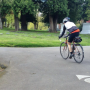 Image of cyclist biking through Riverview Cemetery.