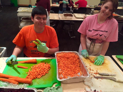 TCKs Mike Lewis '19 and Hanna Lyubinina '19 prepare for the International Fair.