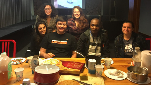 TCKs and friends enjoying a potluck full of comforting foods from board members' homes.