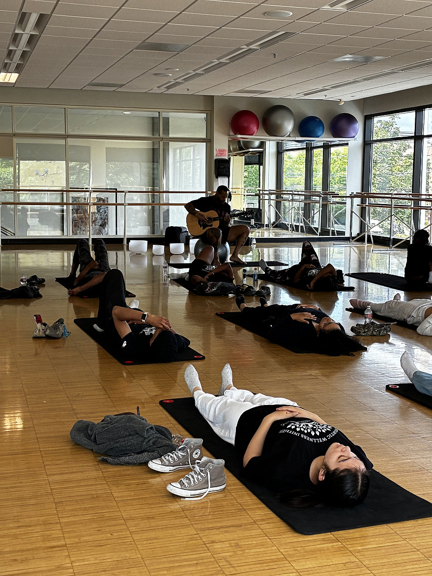 A yoga session at the youth wellness camp led by instructor Nick, who closed class with students resting in savasana while he played acou...