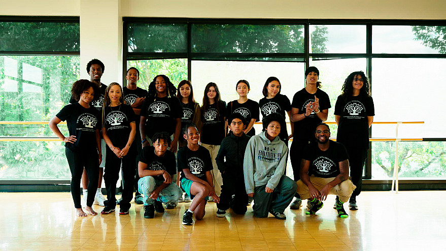 Group photo of students who participated in the HWI Youth Wellness Camp, taken just before beginning a yoga class.