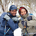 Two students pose on a snowy adventure