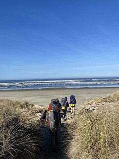 A group of students hikes towards the Pacific Ocean