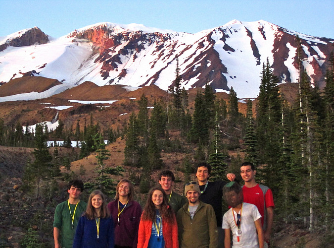 Image shows: a group of people posing in front of Mt Adams