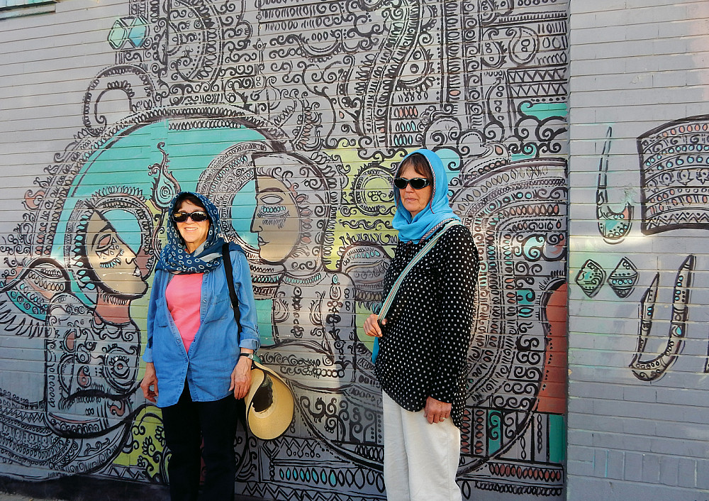 2016: Nancy Siegel and Leslie Silvey BA '70 in front of an Iranian mural.
