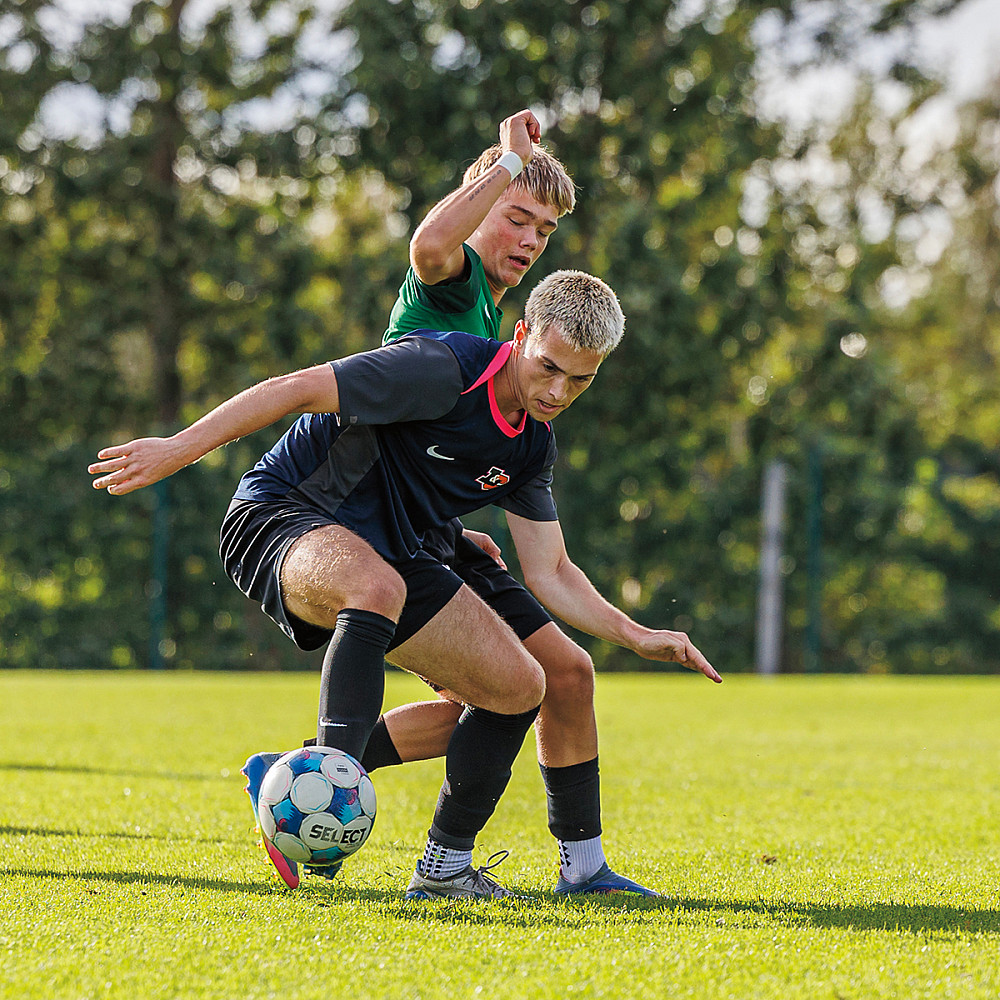 Sam Gunderson BA '28 displays some fancy footwork against a member of the Reykjavík Youth Club boys team.