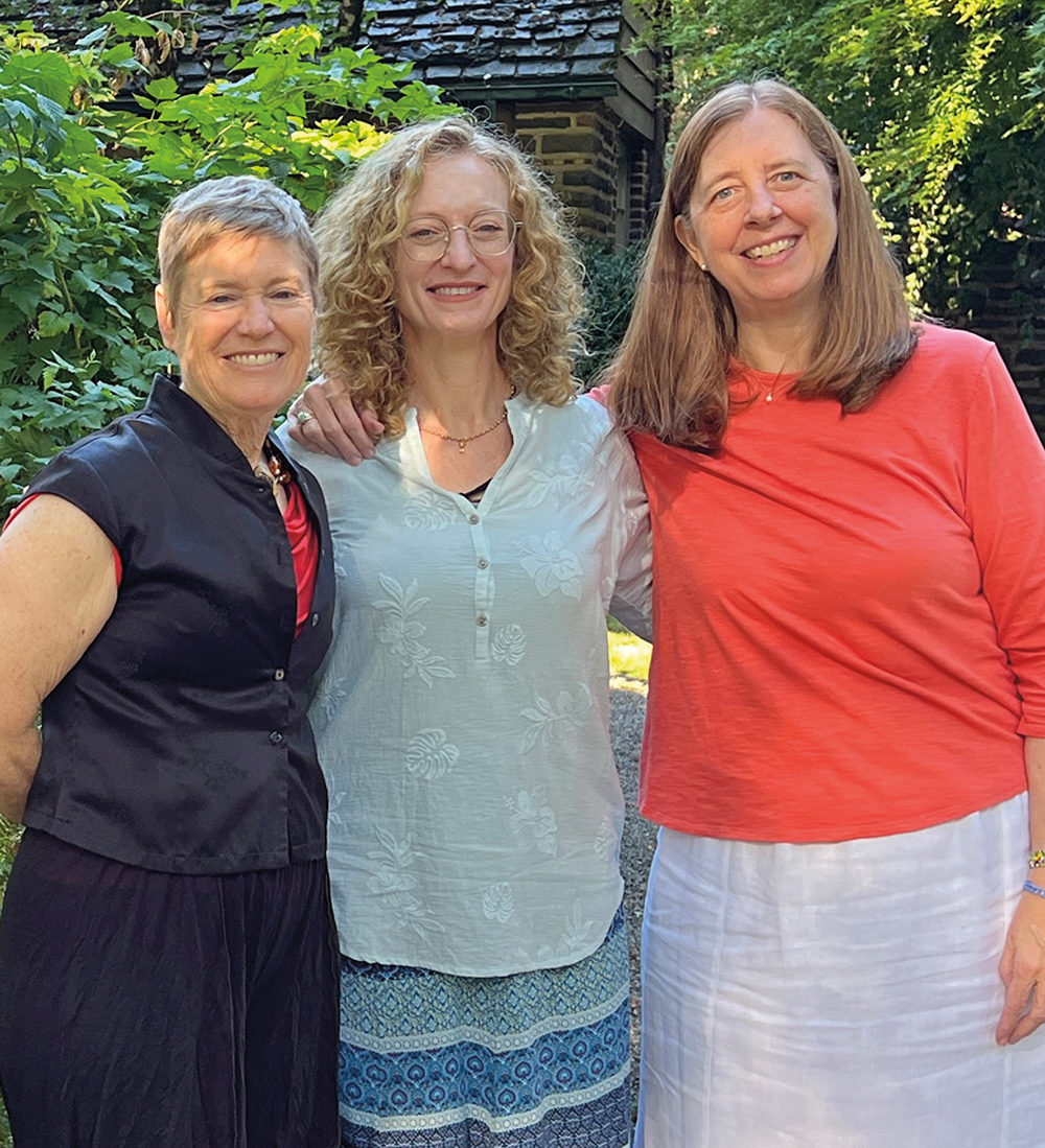 New director Katie Jo Walter BA '09 (center), joined by Ginger Moshofsky BA '83 (left) and Emily Decker BA '85 outside the Alumni Gatehouse.