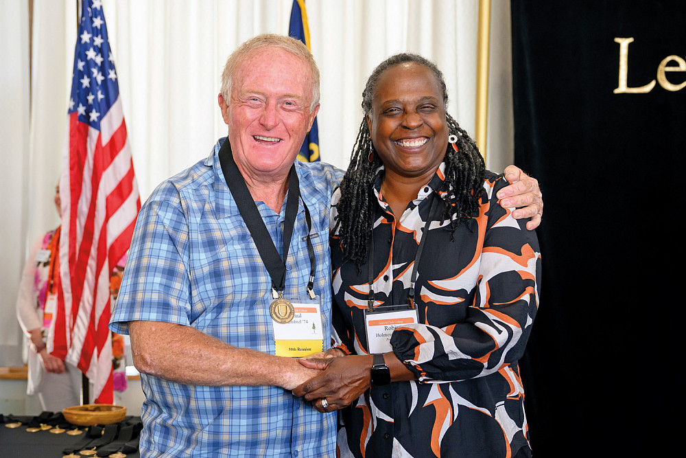 Paul Kimbrel BS '74 is congratulated by President Robin Holmes-Sullivan at the Golden Medallion Luncheon.