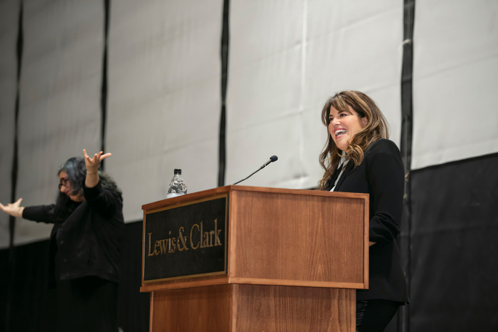 Monica Lewinsky smiles to an audience at lectern