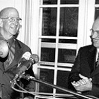 Above: John Rogers (left) rings a bronze school bell to officially open Rogers Hall as President Michael Mooney looks on.