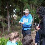 Bob Carlson interacts with kindergarteners on a senses walk in the CREST garden.