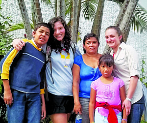 Lucy Roberts CAS '14 and Mia McLaughlin CAS '14 with their host family in El Salvador.