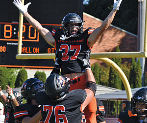 Jordan Lahusky BA '26 celebrates scoring a touchdown.