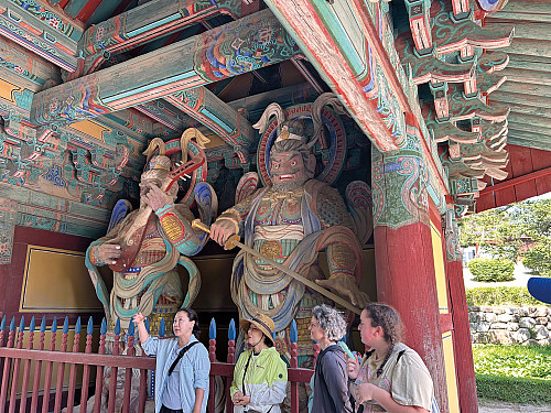 A tour guide shares information about the statues at Bulguksa Temple, Gyeongju, South Korea.