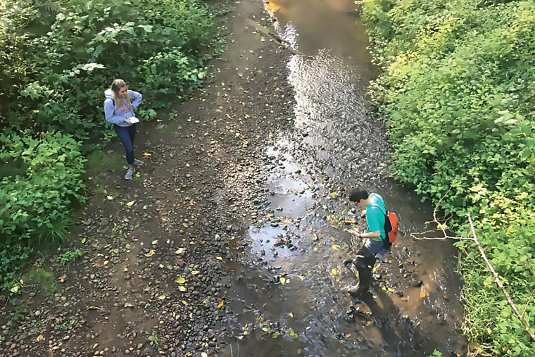 Students taking measurements in Tryon Creek.