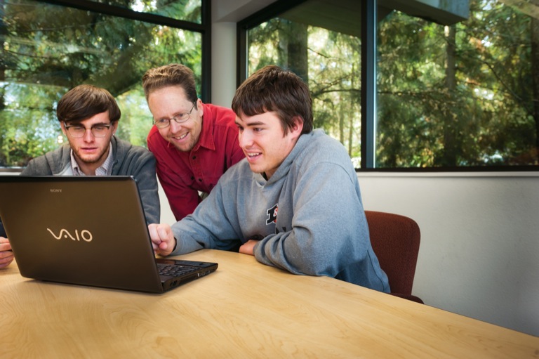 Julian Dale CAS '12; Jens Mache, professor of computer science; and Nic Wilson CAS '12.