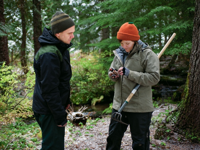 Peter Kennedy, assistant professor of biology, and Logan Higgins BA '11, his lab technician, examine one of the mushrooms they found du...