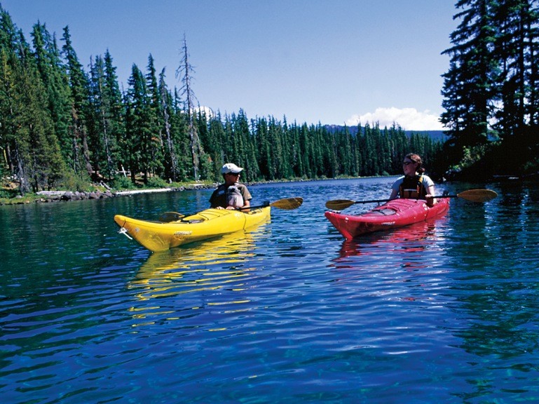 Kyle Miller '10 (left) and Rachael Skinner-Green '10 strike out to kayak Waldo Lake, rated the fourth-clearest lake in the world. This pr...