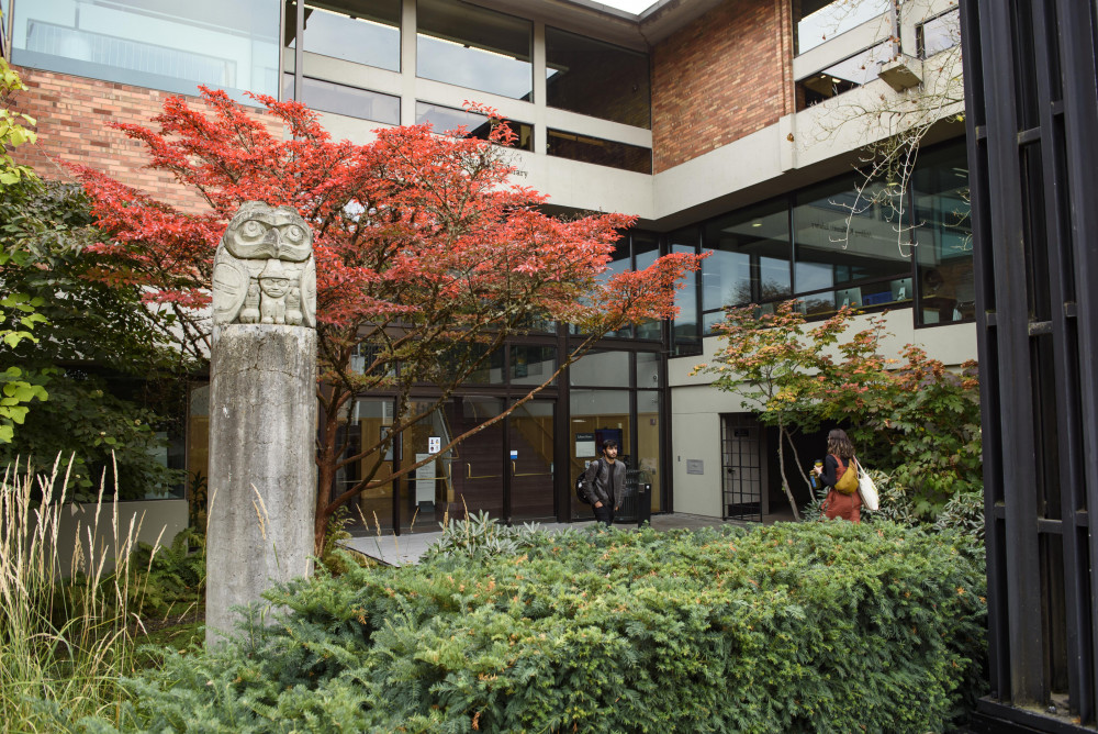 Exterior entrance of Aubrey R. Watzek Library featuring a concrete cast of an owl carving made by Chief Don Lelooska (1933-96) of the Che...