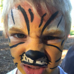 Photo of a child with tiger face paint.