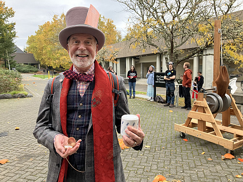 The Mad Hatter enjoying tea time and trebuchet, by Joseph Skudlarek