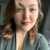 Image of Michelle: A woman with shoulder length curled brunette hair wearing a green sweater