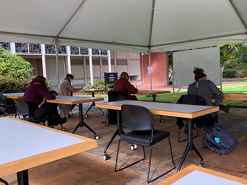 Various grad students fill out toe tags for Hostile Terrain 94 event.