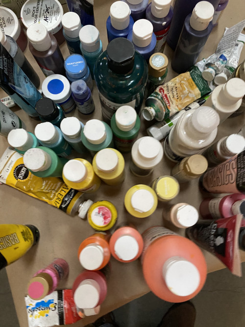 An overhead view of paint bottles at the BLM Art Event at The Armory in Portland, Oregon on April 7, 2021.