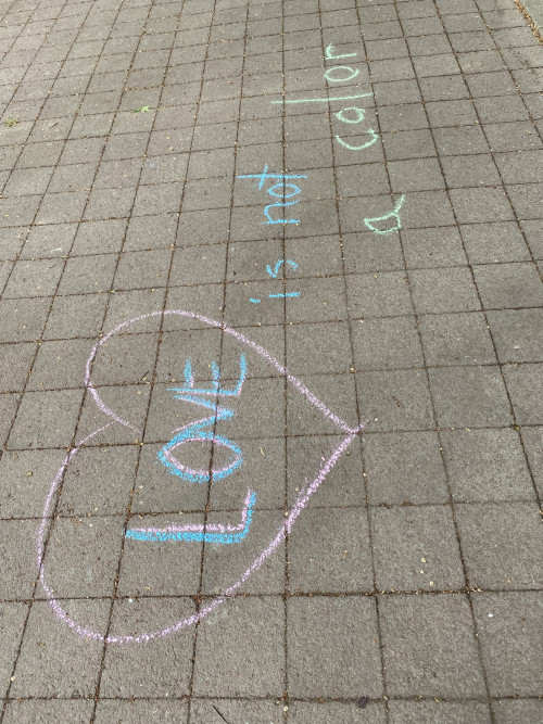 LC Art for Social Change members Mary Andrus, Liv Siulagi, Lawrence Siulagi and Beth Ann Short draw with colored chalk at Shemanski Park ...