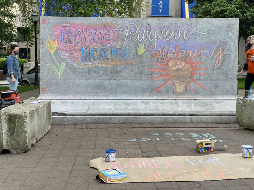 LC Art for Social Change members Mary Andrus, Liv Siulagi, Lawrence Siulagi and Beth Ann Short draw with colored chalk at Shemanski Park ...