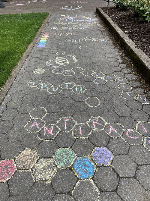 LC Art for Social Change members Mary Andrus, Liv Siulagi, Lawrence Siulagi and Beth Ann Short draw with colored chalk at Shemanski Park ...