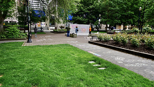 LC Art for Social Change members Mary Andrus, Liv Siulagi, Lawrence Siulagi and Beth Ann Short draw with colored chalk at Shemanski Park ...