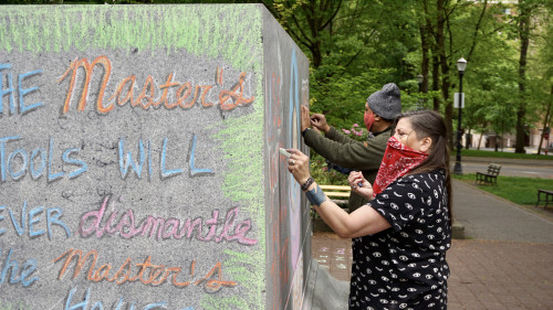 LC Art for Social Change members Mary Andrus, Liv Siulagi, Lawrence Siulagi and Beth Ann Short draw with colored chalk at Shemanski Park ...