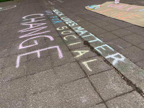 LC Art for Social Change members Mary Andrus, Liv Siulagi, Lawrence Siulagi and Beth Ann Short draw with colored chalk at Shemanski Park ...