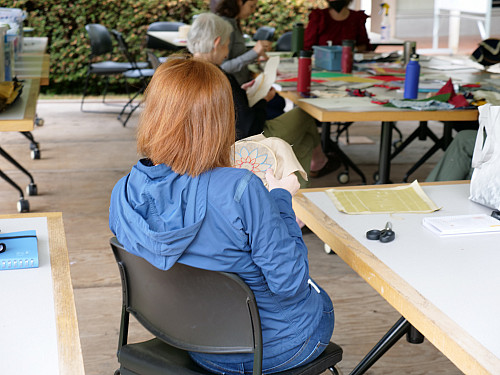 Nina stitching her square.