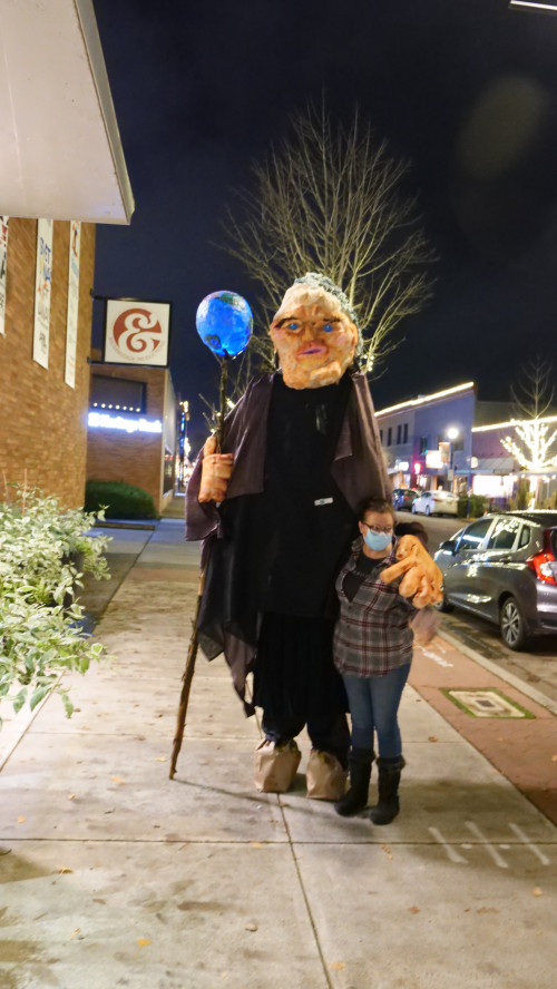 Mary Andrus (in Mother Earth costume), co-chair of Art for Social Change, and a passerby.