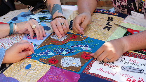 Members of Art for Social Change met to work on the Pandemic Quilt