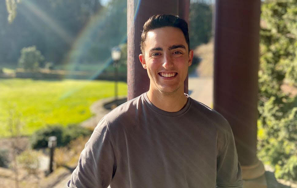 Jordan smiling outside on the L&C campus.