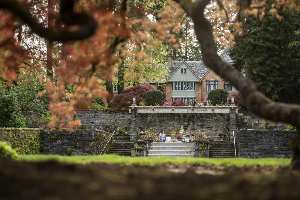 Students sit and chat above the reflecting pool at the estate gardens.