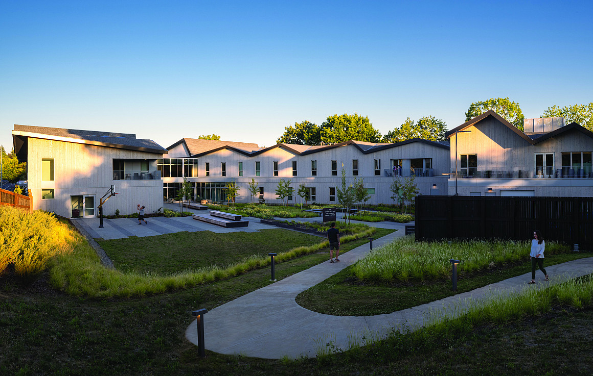 Exterior of a large building with landscaped pathways and gardens.