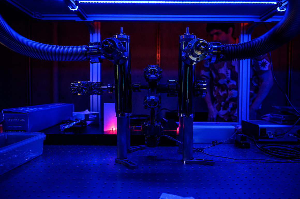 A large machine, lit in blue.