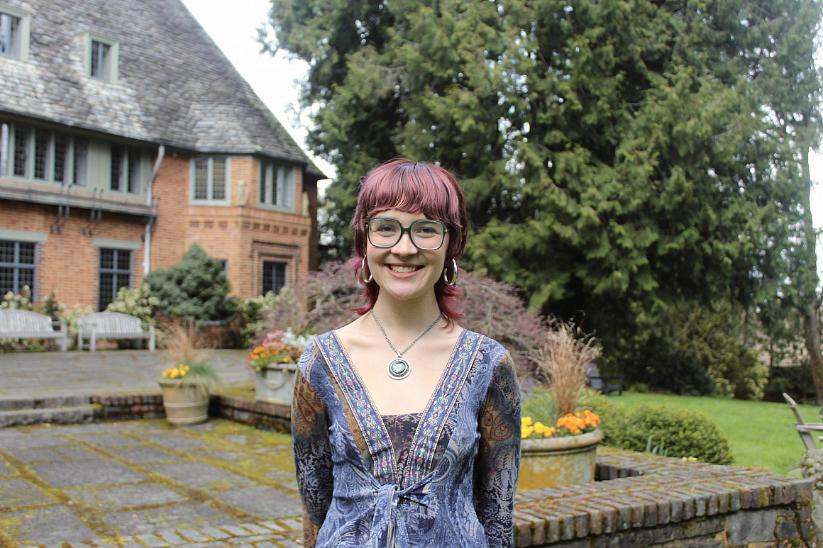 Burton smiling at the camera outside Frank Manor House.