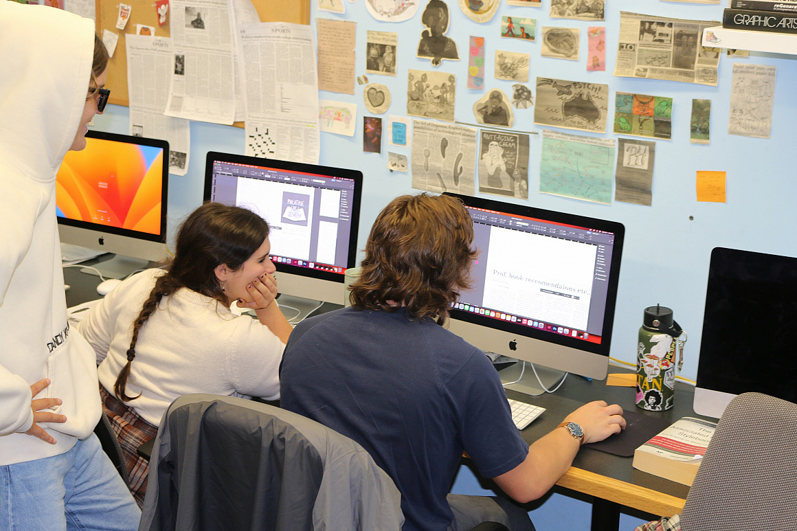 Students working on computers together.