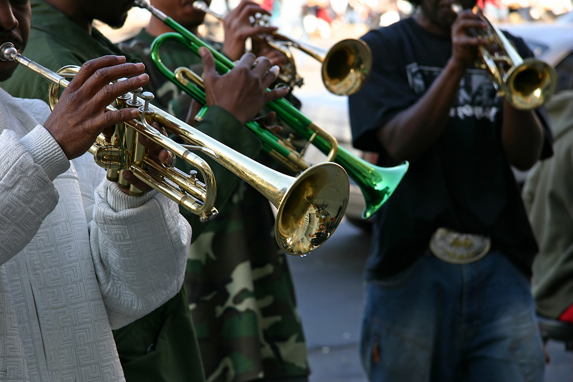 Close up of a person playing a trumpet.