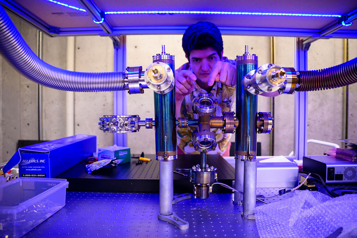 A professor working on a large metal instrument.