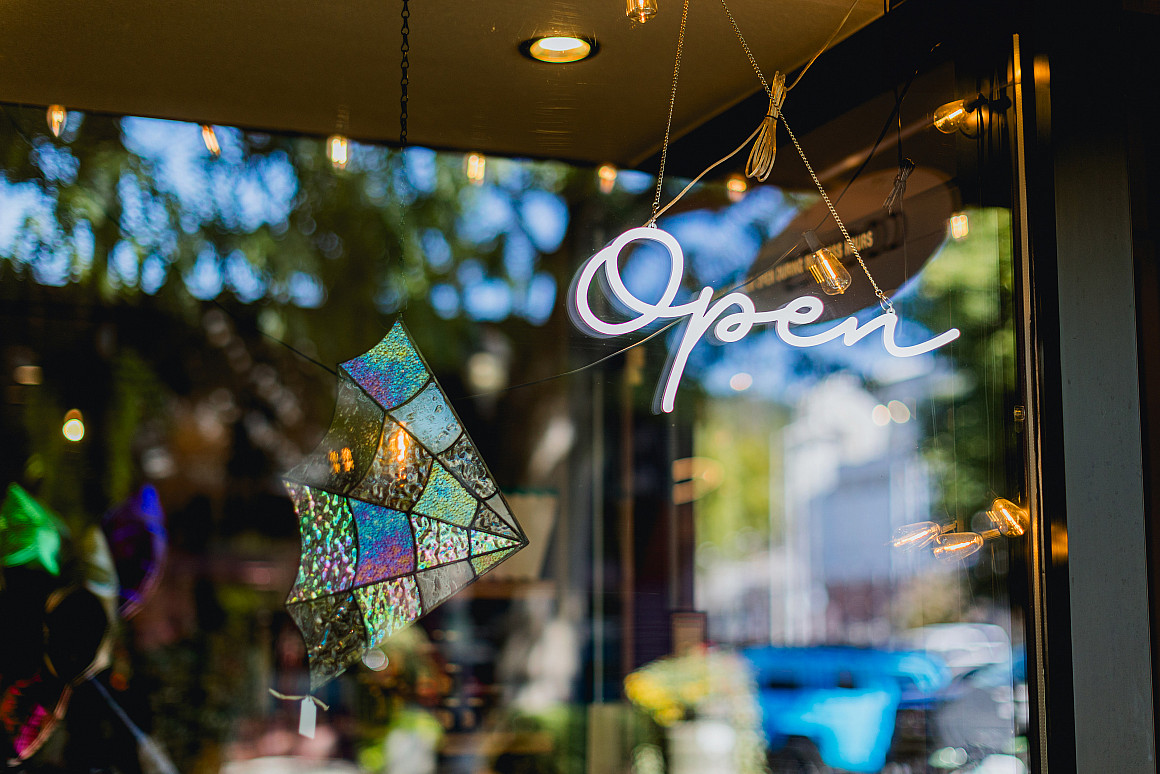 Close-up on a open sign hanging on the door of a local small business in Downtown Camas Washington