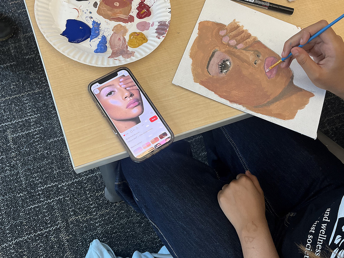 Student painting a face.